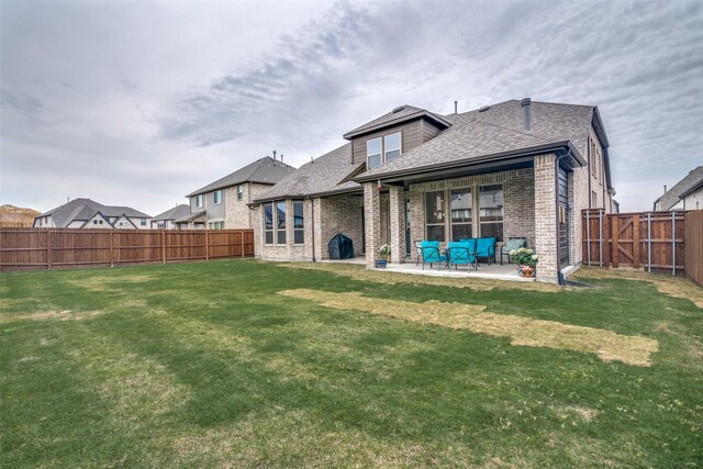 2309 Albion Way, Forney, TX 75126 - back of house with brick siding, a patio area, and roof with shingles
