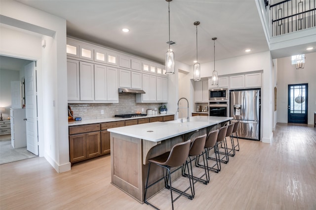 2309 Albion Way, Forney, TX 75126 - kitchen featuring stainless steel appliances, baseboards, under cabinet range hood, light wood-type flooring, and recessed lighting