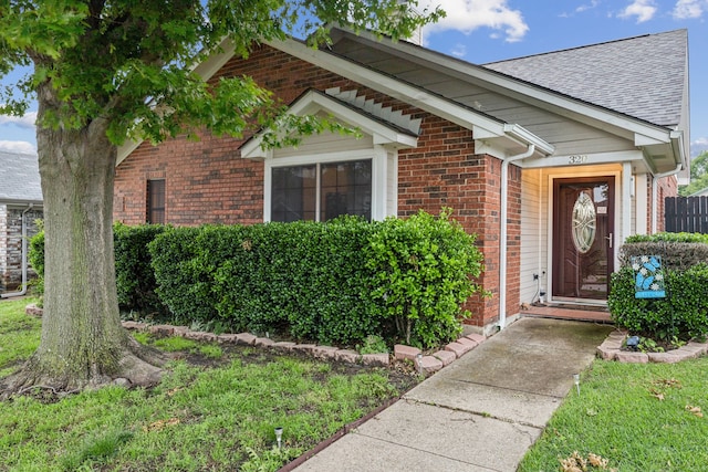 320 Conger Dr, Mesquite, TX 75149 - view of exterior entry featuring brick siding and a shingled roof