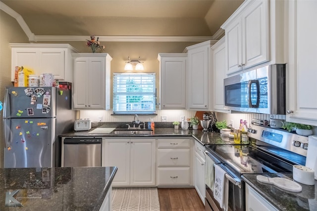 1001 Cabernet Dr, Abilene, TX 79601 - kitchen featuring appliances with stainless steel finishes, a sink, white cabinets, crown molding, and wood finished floors