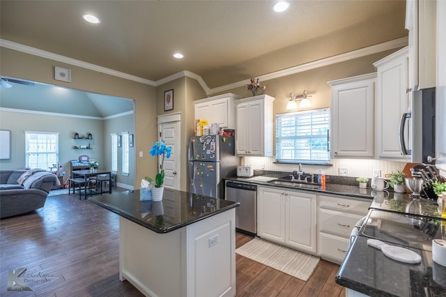 1001 Cabernet Dr, Abilene, TX 79601 - kitchen featuring stainless steel appliances, a sink, open floor plan, white cabinets, and ornamental molding