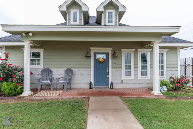 1001 Cabernet Dr, Abilene, TX 79601 - property entrance with covered porch, a lawn, and roof with shingles