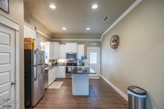 1001 Cabernet Dr, Abilene, TX 79601 - kitchen with appliances with stainless steel finishes, dark countertops, white cabinets, crown molding, and a center island