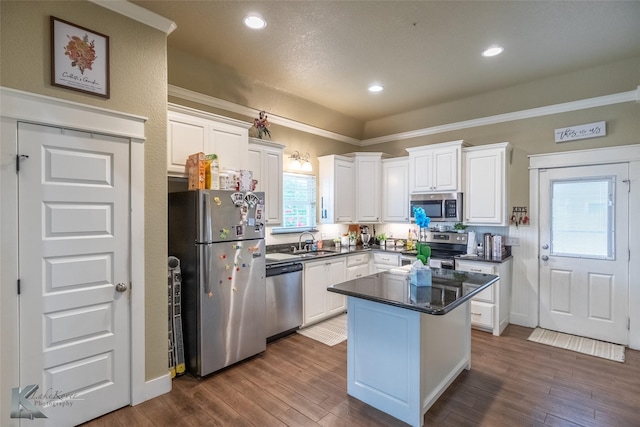1001 Cabernet Dr, Abilene, TX 79601 - kitchen with appliances with stainless steel finishes, a sink, dark countertops, white cabinets, and dark wood finished floors