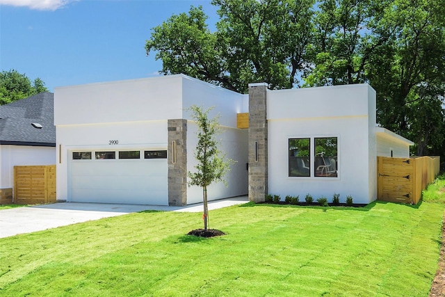 3900 De Maggio Ave, Dallas, TX 75210 - modern home with an attached garage, concrete driveway, and stucco siding