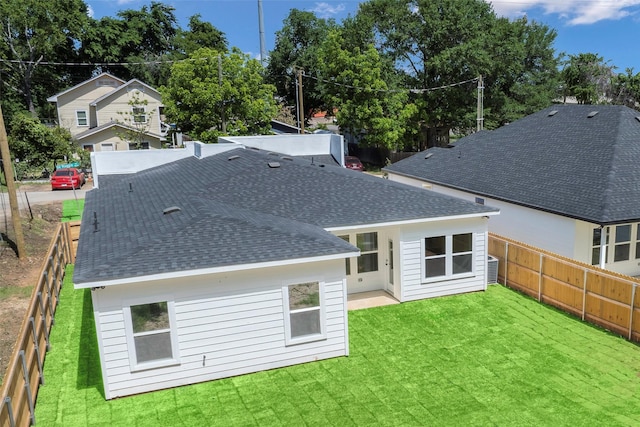 3900 De Maggio Ave, Dallas, TX 75210 - back of house featuring roof with shingles and a fenced backyard