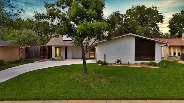 view of front of property featuring driveway and brick siding