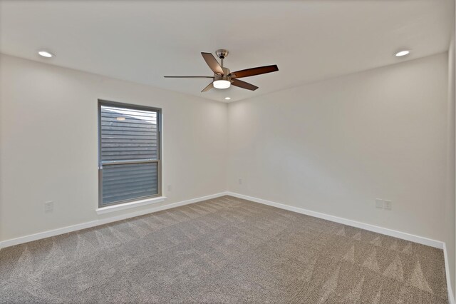 empty room with carpet, a ceiling fan, baseboards, and recessed lighting
