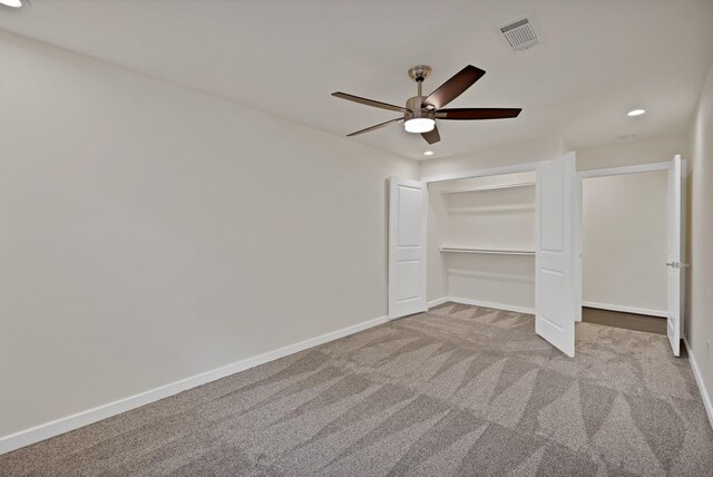 unfurnished bedroom with recessed lighting, carpet flooring, baseboards, ceiling fan, and a closet