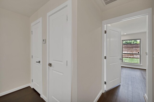 hall featuring dark wood finished floors and baseboards