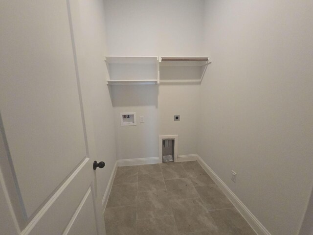 laundry room with electric dryer hookup, hookup for a washing machine, baseboards, and tile patterned floors