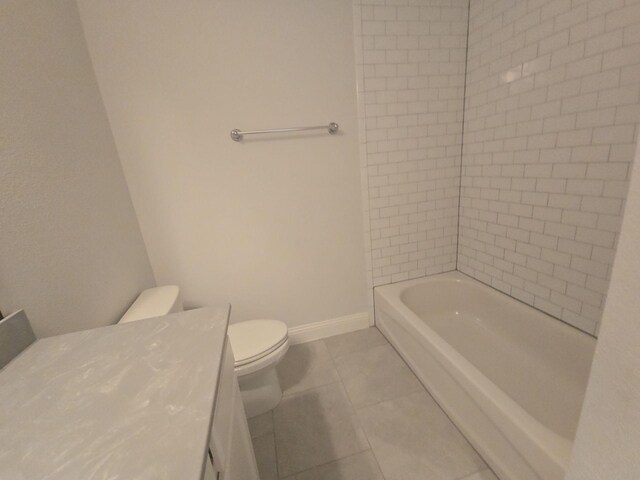 full bathroom with toilet, vanity, baseboards, and tile patterned flooring