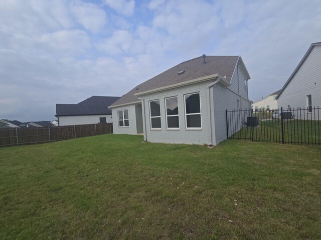 rear view of property with brick siding