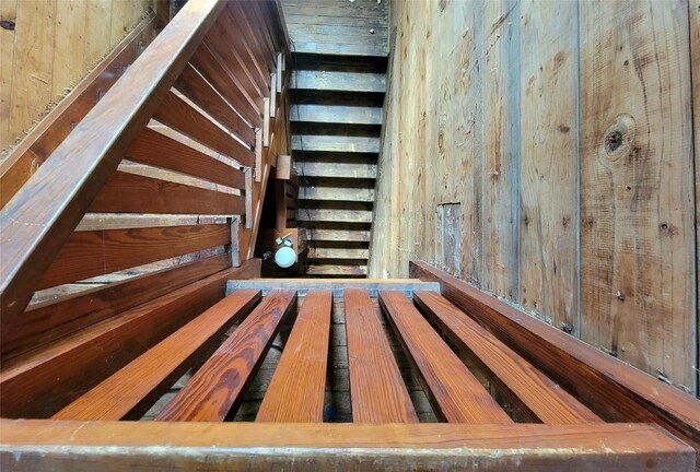 1208 W Broadway, Clarksville, TX 75426 - stairs featuring wood walls