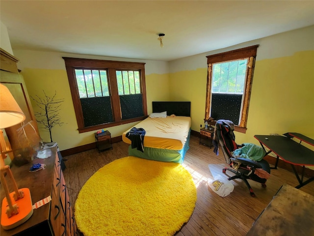 1208 W Broadway, Clarksville, TX 75426 - bedroom featuring wood finished floors and baseboards