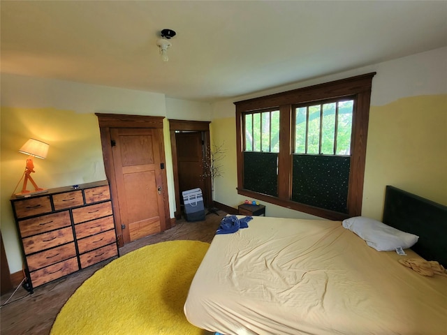 1208 W Broadway, Clarksville, TX 75426 - bedroom featuring dark wood-style flooring and baseboards