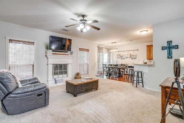 558 Ascot Way, Azle, TX 76020 - living room featuring carpet flooring, a ceiling fan, baseboards, and a glass covered fireplace