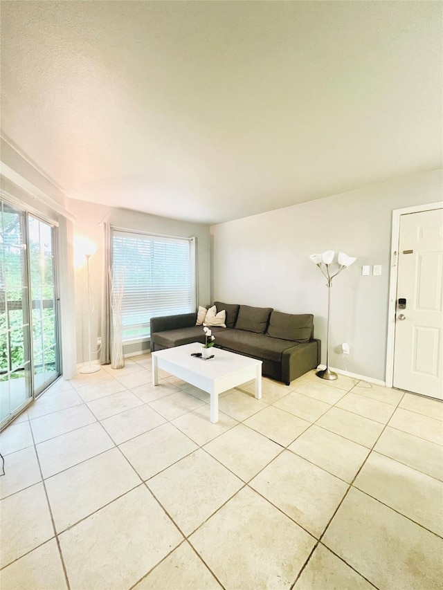 living area with plenty of natural light and light tile patterned flooring