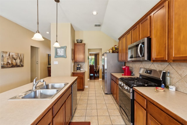 2377 Sunshine Dr, Little Elm, TX 75068 - kitchen featuring stainless steel appliances, a sink, brown cabinets, backsplash, and light countertops