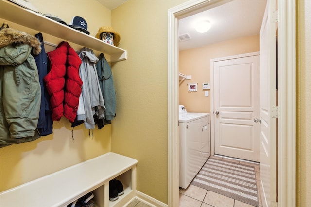 2377 Sunshine Dr, Little Elm, TX 75068 - mudroom with washer and clothes dryer and light tile patterned floors