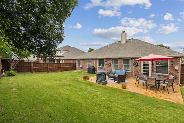 2377 Sunshine Dr, Little Elm, TX 75068 - back of house featuring brick siding, a patio, roof with shingles, a chimney, and an outdoor hangout area