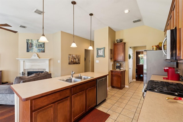 2377 Sunshine Dr, Little Elm, TX 75068 - kitchen featuring appliances with stainless steel finishes, a sink, open floor plan, light countertops, and lofted ceiling