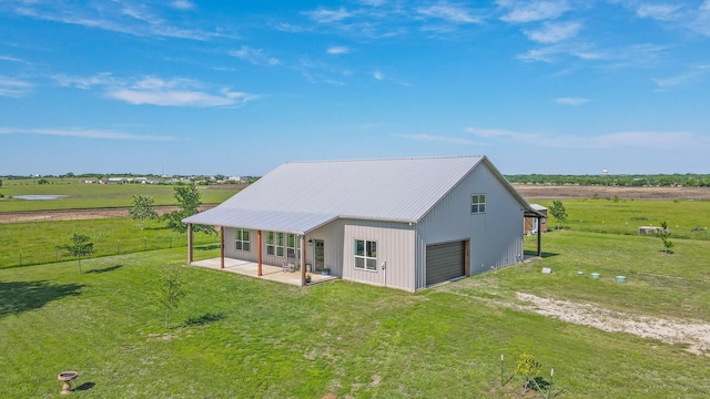 5050 Helton Rd, Justin, TX 76247 - back of property featuring a garage, a yard, driveway, and metal roof