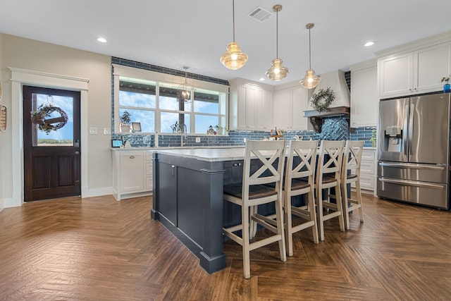 5050 Helton Rd, Justin, TX 76247 - kitchen with stainless steel fridge with ice dispenser, custom range hood, white cabinets, a center island, and recessed lighting