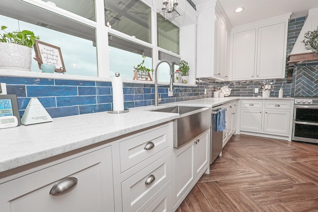 5050 Helton Rd, Justin, TX 76247 - kitchen featuring a sink, stainless steel appliances, recessed lighting, backsplash, and white cabinets