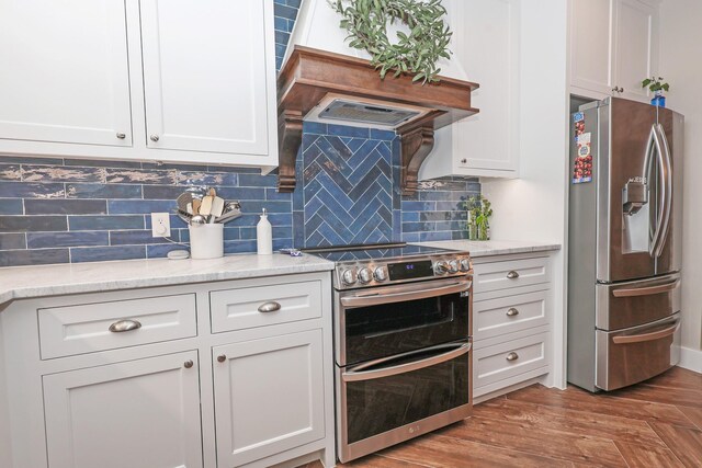 5050 Helton Rd, Justin, TX 76247 - kitchen featuring appliances with stainless steel finishes, white cabinetry, backsplash, and light stone counters