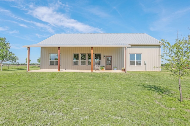 5050 Helton Rd, Justin, TX 76247 - back of property featuring a patio, a lawn, and metal roof