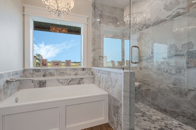 5050 Helton Rd, Justin, TX 76247 - bathroom with a chandelier, a garden tub, and a shower stall