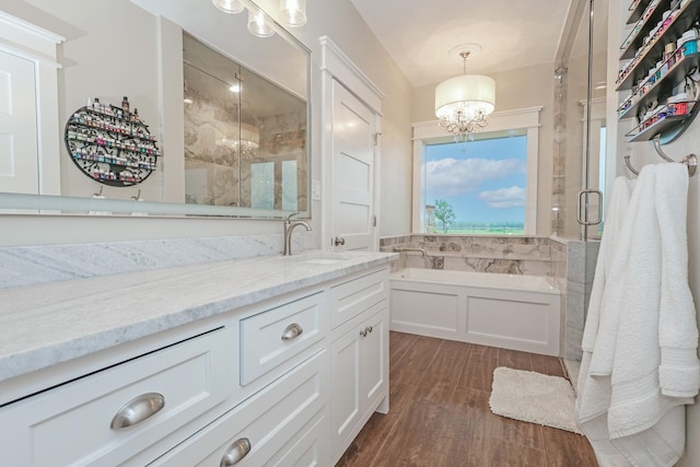 5050 Helton Rd, Justin, TX 76247 - full bath featuring a chandelier, wood finished floors, a stall shower, vanity, and a bath