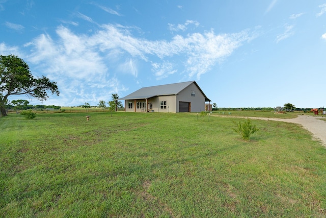 5050 Helton Rd, Justin, TX 76247 - view of grassy yard featuring a detached garage, driveway, an outbuilding, a view of countryside, and a pole building