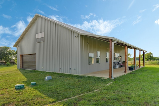 5050 Helton Rd, Justin, TX 76247 - view of property exterior with a yard, a detached garage, a patio, and board and batten siding