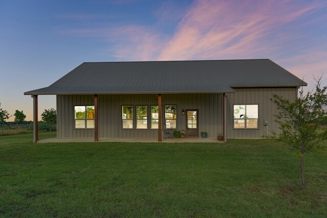 5050 Helton Rd, Justin, TX 76247 - back of house featuring a lawn, board and batten siding, and a patio