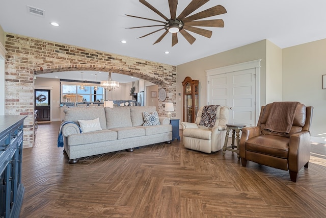 5050 Helton Rd, Justin, TX 76247 - living area with arched walkways, ceiling fan, recessed lighting, and a chandelier