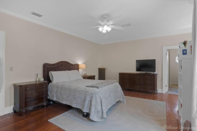 bedroom with wood finished floors, crown molding, baseboards, and a ceiling fan
