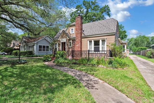 view of front of property with a chimney and roof with shingles