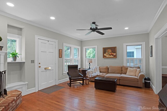 living area featuring light wood-style floors, ceiling fan, ornamental molding, recessed lighting, and baseboards