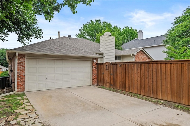 2617 Jacques Ln, Mckinney, TX 75070 - garage with fence, central AC unit, and concrete driveway
