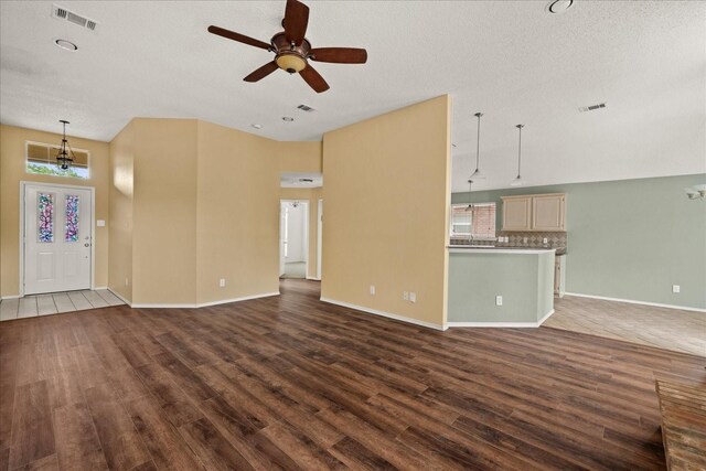 2617 Jacques Ln, Mckinney, TX 75070 - unfurnished living room featuring dark wood finished floors, ceiling fan, baseboards, and a textured ceiling
