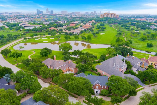 view of urban area with a nearby body of water, a local golf course, and nearby suburban area
