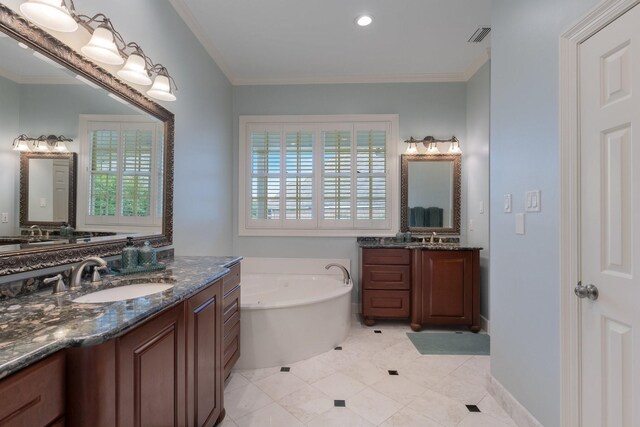 full bath featuring healthy amount of natural light, a garden tub, two vanities, ornamental molding, and tile patterned floors
