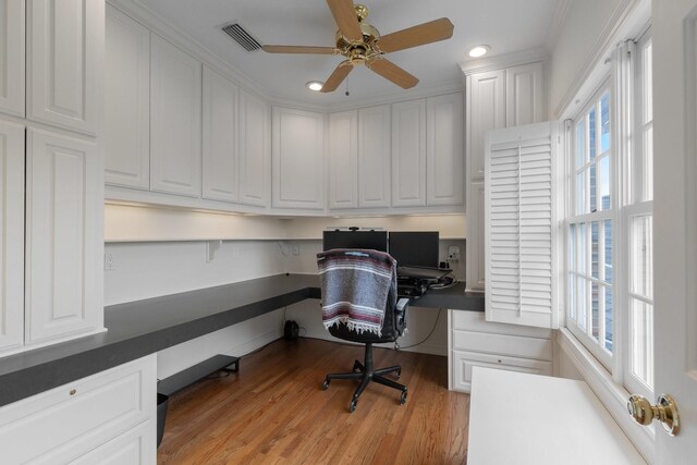 office with built in desk, plenty of natural light, recessed lighting, and a ceiling fan
