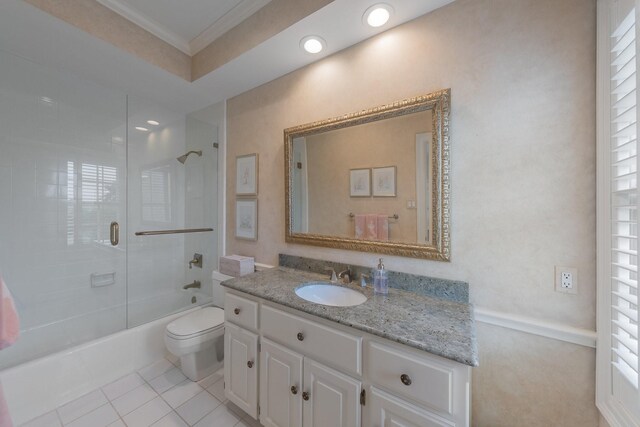 bathroom featuring ornamental molding, toilet, bathing tub / shower combination, vanity, and tile patterned floors