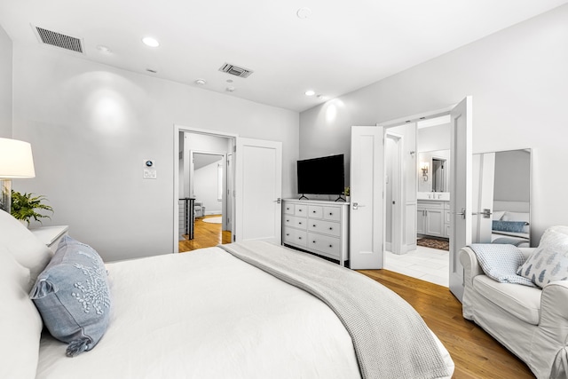 3420 Rosedale Ave Unit 6, University Park, TX 75205 - bedroom featuring recessed lighting, wood finished floors, and ensuite bath