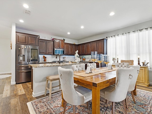 1111 Burlingame Dr, Cleburne, TX 76033 - dining room with light wood-style flooring, recessed lighting, and baseboards
