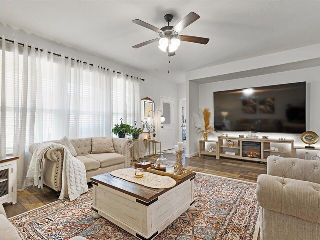 1111 Burlingame Dr, Cleburne, TX 76033 - living area featuring ceiling fan, wood finished floors, and baseboards
