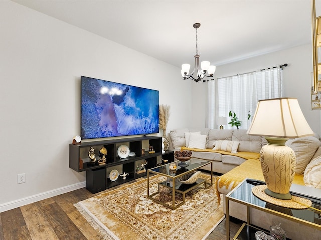 1111 Burlingame Dr, Cleburne, TX 76033 - living room featuring a chandelier, wood finished floors, and baseboards